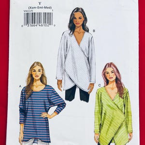 May include: A sewing pattern titled "VERY EASY VOGUE" with the number V9111. The pattern features illustrations of three different long-sleeve tops. The tops are in white, blue and green. The pattern includes the size range (Xsm-Sml-Med).