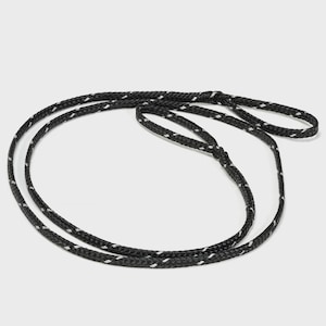 May include: Black and white rope with a loop at each end. The rope is made of a durable material and features a repeating pattern of white dashes along its length. The rope is designed for various uses, such as securing items or creating a handle.