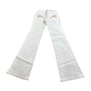May include: White denim jeans with a flared leg design. The back pockets feature gold-colored embroidered detailing. The jeans are laid flat, showcasing the back view and the flared leg style.