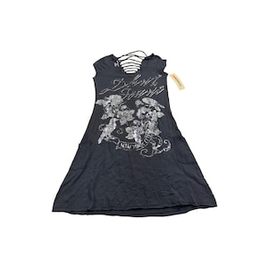 May include: Dark grey dress featuring a floral and text design. The dress has a scoop neck with crisscross straps, short sleeves, and two front pockets. The text on the dress says "Brooklyn Forever" and "New York City".