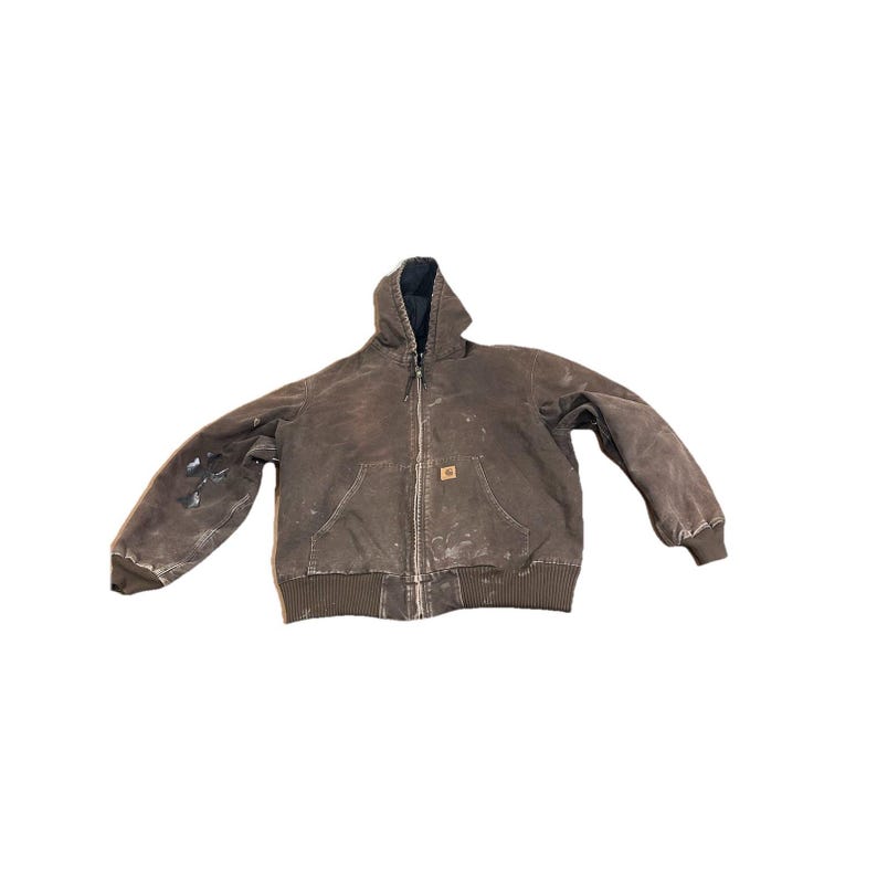 May include: Brown hooded work jacket with a full zipper closure, two front pockets, and a ribbed hem and cuffs. The jacket has a worn appearance with paint marks and a small logo patch.