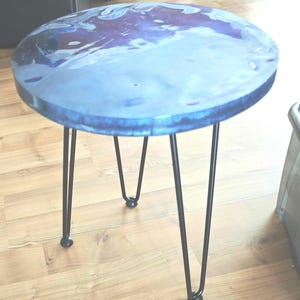 Mesa auxiliar redonda de resina epoxi.