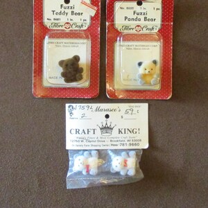 May include: Three packages of miniature teddy bears and panda bears. Two are in red and white packaging, labeled "Fuzzi Teddy Bear" and "Fuzzi Panda Bear," each 1 inch in size. The third package contains two small white bears.