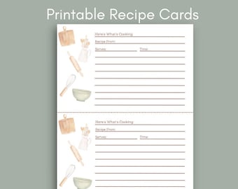 May include: Printable recipe cards with a watercolor design of kitchen tools. The cards have lines for writing down recipe information, including the recipe name, source, servings, and time. The text "Here's What's Cooking" is at the top of each card. The text "Prints two cards per page" is at the bottom of the image.