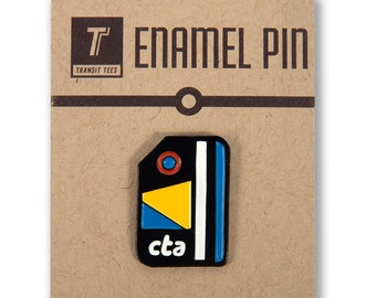 May include: A black enamel pin with a stylized graphic of a CTA Ventra card. The pin features a yellow triangle, blue rectangle, and white stripe. The text "cta" is printed in white on the pin.