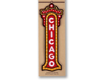May include: Iron-on patch featuring a red and yellow sign with the word "CHICAGO" in white lettering. The patch is designed in Chicago and is packaged on a brown card.