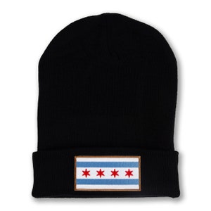 May include: Black knit beanie with a brown and white patch featuring the Chicago flag with four red stars on a blue background.