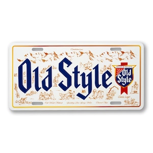 May include: White license plate with the words "Old Style" in large blue letters. The plate features a mountain range and illustrations in brown, with the Heileman's Old Style logo on the right.