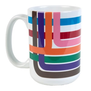 May include: White ceramic mug with a large handle, featuring a colorful geometric design of intersecting lines in blue, orange, pink, green, purple, red, and brown. The mug has a glossy finish and is suitable for hot or cold beverages.