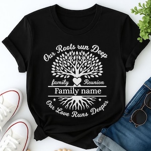 May include: Black t-shirt with white text and a tree graphic. The text reads "Our Roots run Deep" above a tree design, with "family Reunion" and "Family name" below. The bottom text says "Our Love Runs Deeper".