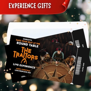 May include: Black tickets for a live experience of "The Traitors", showing a round table with people seated around it. The tickets are in an envelope, with "Experience Gifts" written at the top.