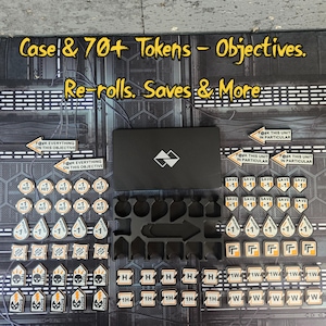 May include: A black case with a logo, surrounded by game tokens. The tokens are various shapes and colors, including white, orange, and black. Text on the tokens includes "Hit", "Save", and "Shock". The text "Case & 70+ Tokens - Objectives. Re-rolls. Saves & More" is also visible.