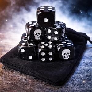 May include: A set of black dice with white pips and skull motifs. The dice are arranged in a pyramid shape, some displaying a skull image. They are presented on a black velvet pouch, creating a dark, gothic theme.