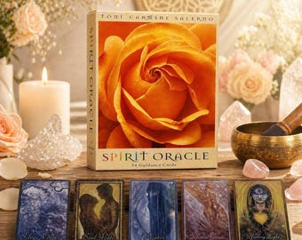 May include: A Spirit Oracle deck with 54 guidance cards, featuring an orange rose on the box. The cards are displayed on a wooden surface with crystals, candles, and a singing bowl. Each card has a unique illustration and title.