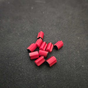 May include: A group of red and black keycaps for a mechanical keyboard.