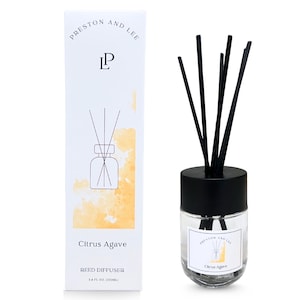 May include: A clear glass reed diffuser with black reeds and a black cap. The product is labelled "Citrus Agave" and "Preston and Lee". The packaging is white with the brand name and a graphic of the diffuser.