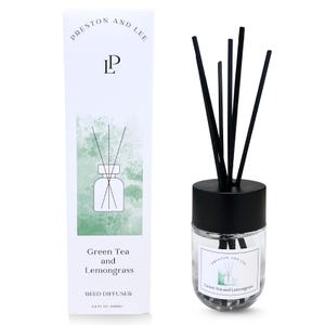 May include: A clear glass reed diffuser with black reeds and a black cap. The product is labeled "Green Tea and Lemongrass" and is packaged in a white box with the brand name "Preston and Lee". The diffuser contains 3.4 fl oz (100ml).