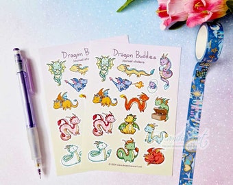 May include: Two sheets of colorful stickers featuring cute cartoon dragons in various poses. The stickers are labeled "Dragon Buddies Journal Stickers" and "Dragon B Journal Stickers".