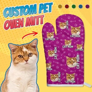 May include: Purple oven mitt with a repeating pattern of a cat's face and the text "Cat Mom".
