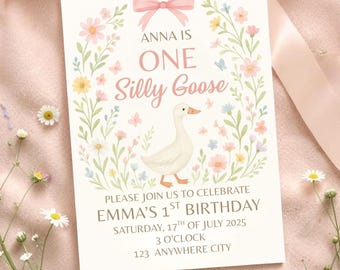 May include: A rectangular birthday invitation card featuring a white background with a pink bow at the top, a central illustration of a white goose, and a floral wreath. Text reads: ANNA IS ONE Silly Goose, PLEASE JOIN US TO CELEBRATE EMMA'S 1ST BIRTHDAY, SATURDAY, 17TH OF JULY 2025, 3 O'CLOCK, 123 ANYWHERE CITY.