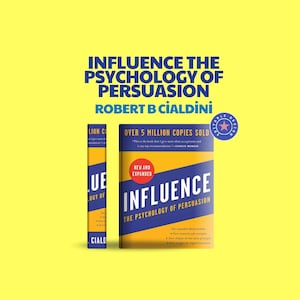 May include: A book titled "Influence: The Psychology of Persuasion" by Robert B. Cialdini. The book has a blue and yellow cover with the title in large, bold letters. The book's spine is also visible, with the title and author's name.