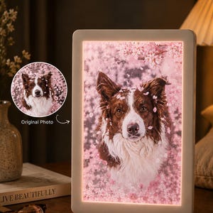 May include: A rectangular light box featuring a portrait of a brown and white dog surrounded by pink cherry blossoms. A circular inset in the upper left corner displays the original photo with the text Original Photo and an arrow pointing to the frame.