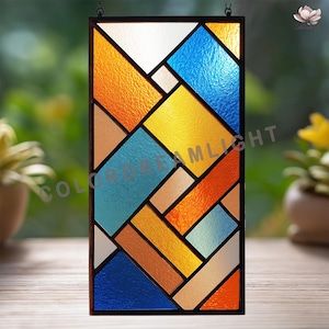 May include: A rectangular stained glass panel with a geometric design. The panel features a variety of colors, including orange, blue, yellow, and white, arranged in a patchwork pattern. The text "COLORDREAMLIGHT" is visible on the left side.
