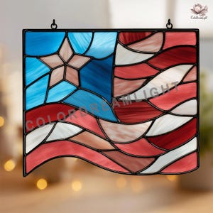 May include: Stained glass panel depicting the American flag. The design features a blue field with a star, and red and white stripes. The panel is framed in black and includes the text "COLOR DREAM LIGHT".