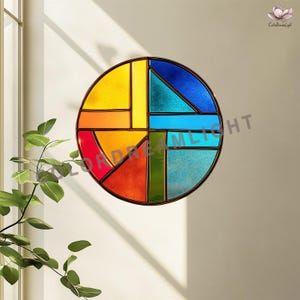 May include: A round stained glass window with a geometric design. The window features a variety of colors, including yellow, orange, red, green, blue, and turquoise, set within a dark brown frame. The design is reminiscent of abstract art.