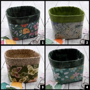 May include: Four fabric storage baskets with folded rims. Basket 1 has a dark green floral print. Basket 2 features a light gray floral pattern with a lime green interior. Basket 3 displays a butterfly print. Basket 4 shows a light blue floral design.