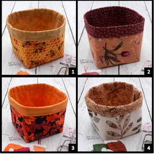 May include: Four fabric storage baskets with different patterns. One has a honeycomb and bee design, another has a floral pattern with a tulip, a third has autumn leaves, and the last has a leaf pattern. Each basket has a contrasting trim.