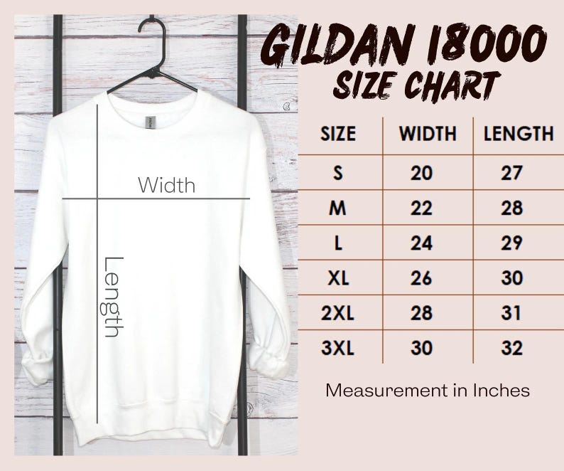 May include: A white Gildan 18000 sweatshirt hanging on a black hanger. The image includes a size chart with measurements in inches for sizes S to 3XL. The chart shows width and length measurements.