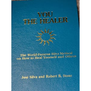 May include: A teal book titled "YOU THE HEALER" with gold lettering and a sunburst design. The book cover includes the text "The World-Famous Silva Method on How to Heal Yourself and Others" and the authors' names, José Silva and Robert B. Stone.
