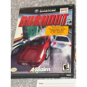 May include: A Nintendo GameCube video game case for "Burnout." The cover art features a red sports car in a crash scene with the game's title in large, red letters. The case has a sticker that says "Display Box Only."