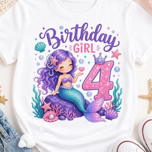May include: A white short-sleeve t-shirt featuring a graphic of a purple-haired mermaid sitting on a rock, surrounded by sea life and bubbles. The text reads Birthday Girl above the mermaid, with a large glittery pink number 4 to the right.