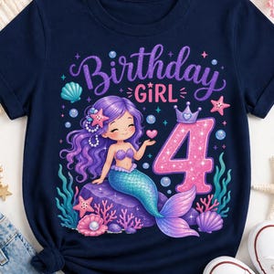 May include: A navy blue t-shirt featuring a graphic of a purple-haired mermaid sitting on a rock, surrounded by coral, seashells, and bubbles. The text reads Birthday GIRL above a large, glittery pink number 4 with a small crown on top.