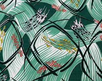 May include: Green fabric with a white background and a repeating pattern of black, green, and yellow abstract shapes. The shapes are outlined in black and have a textured look.