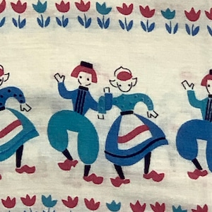 May include: A white fabric with a repeating pattern of blue and red tulips and figures of people wearing traditional Dutch clothing. The figures are dancing and wearing blue and white clothing with red accents.