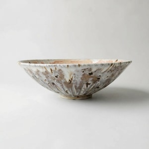 May include: A trio of ceramic mugs with a speckled, matte finish in cream, light grey, and dark grey. Each mug features a simple, minimalist design, ideal for tea or coffee.