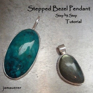 May include: Two silver pendants with green gemstones set in a stepped bezel setting. The pendant on the left has a bright teal green stone, while the pendant on the right has a darker green stone with a hint of gold.
