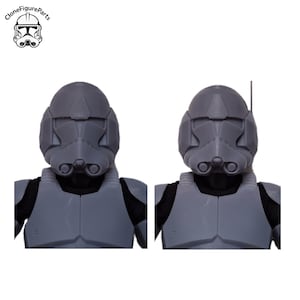 May include: Two grey action figure helmets and chest armour, with the CloneFigureParts logo in the upper left corner. One helmet has an antenna. The armour is a solid grey colour, with black accents. The helmets have a detailed design.