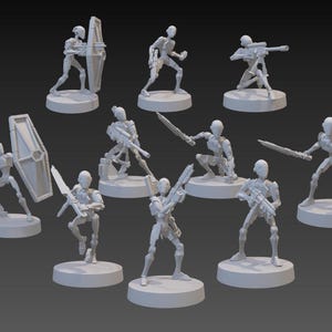 May include: A collection of light gray miniature figurines, each depicting a humanoid figure in various action poses. Some figures hold weapons like swords, shields, and rifles. The figurines are on circular bases, suggesting they are designed for tabletop gaming or display.