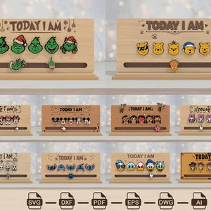 Puede incluir: Una colección de soportes de madera rectangulares con el texto TODAY I AM y varios iconos de caras de personajes. Cada soporte incluye una ranura horizontal con un marcador móvil para indicar el estado de ánimo diario.