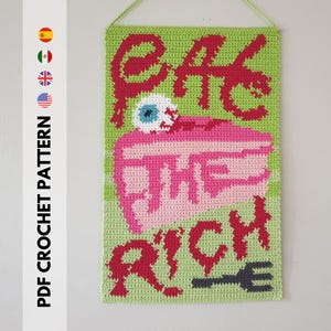 May include: A green crochet wall hanging featuring the phrase "EAT THE RICH" in red, a pink cake with a blue eyeball, and a grey fork. The text "PDF CROCHET PATTERN" is on the left side.