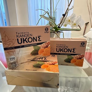 May include: Three boxes of Turmeric Kangen Ukon dietary supplement. The boxes are light brown with the product name in large, dark brown letters. The boxes also feature images of turmeric root and powder. The text "Made in Japan" is visible.