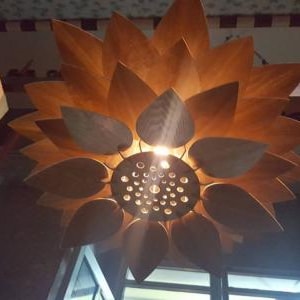 Detail view of laser-cut slot design on wooden pendant lamp petals, highlighting living hinge structure for flexibility
