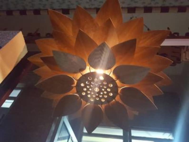 Detail view of laser-cut slot design on wooden pendant lamp petals, highlighting living hinge structure for flexibility