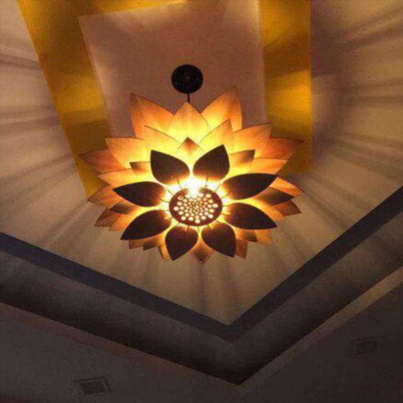 Modern wooden pendant lamp with minimalist flower design, made using laser-cut living hinge pattern, ideal for hanging ceiling lighting