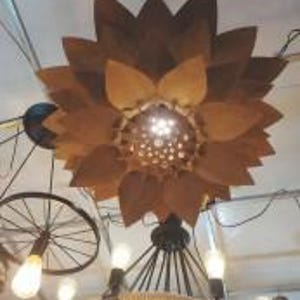 Hanging ceiling light with flower-style laser-cut shade casting decorative shadows, designed for 3mm–5mm plywood or MDF