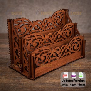 May include: A wooden desk organizer with three compartments. The organizer is made of brown wood and features intricate, decorative cut-out designs. The text "Updated Version" and the dimensions 3mm, 4mm, and 6mm are visible.